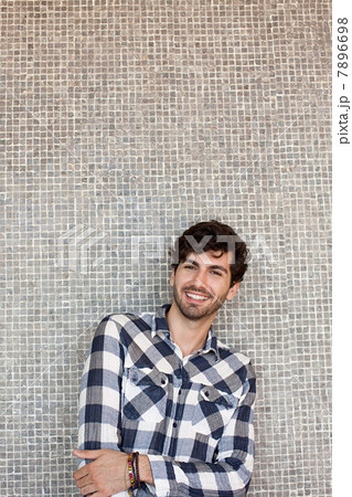 Portrait of young man in front of wall 7896698