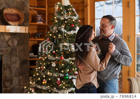 Mature couple dancing by Christmas tree Mature couple dancing by Christmas tree 7896814