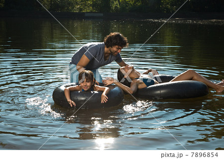 Couple and daughter having fun in lake 7896854