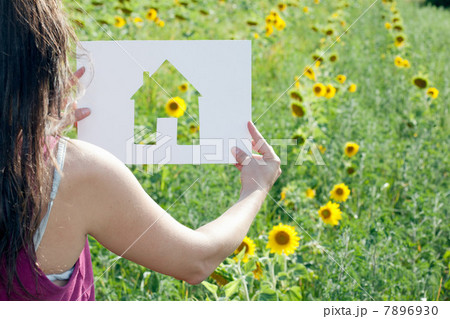 Woman holding card with house shape 7896930