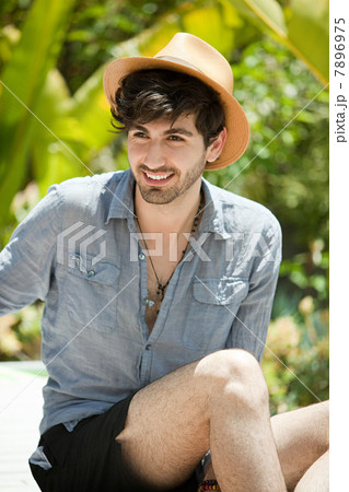 Young man wearing throwing trilby 7896975