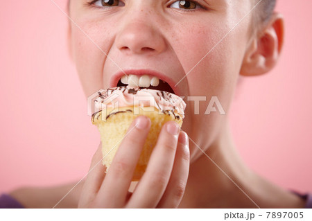 Girl biting cupcake Girl biting cupcake 7897005