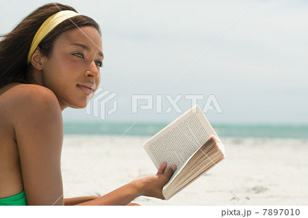 Woman at the beach with book 7897010