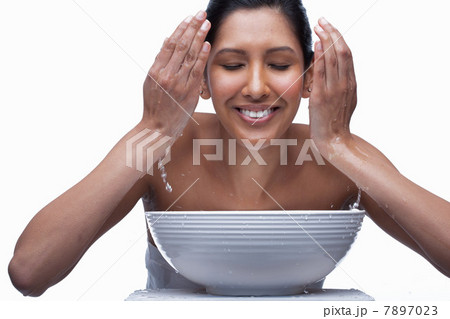 Young woman washing face 7897023