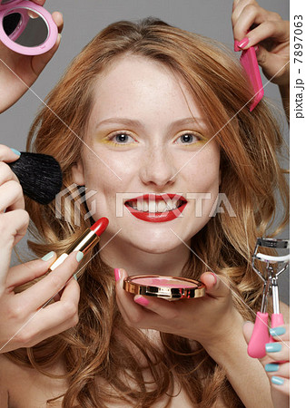 Young woman with make-up artists 7897063