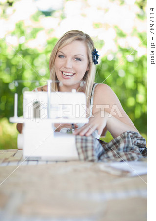 Woman working on sewing machine Woman working on sewing machine 7897114