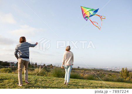 Young couple flying a kite Young couple flying a kite 7897224