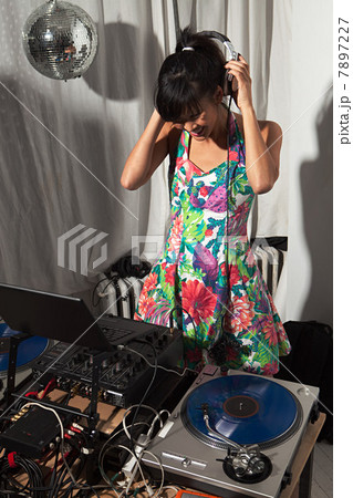 Disc jockey wearing headphones at party 7897227