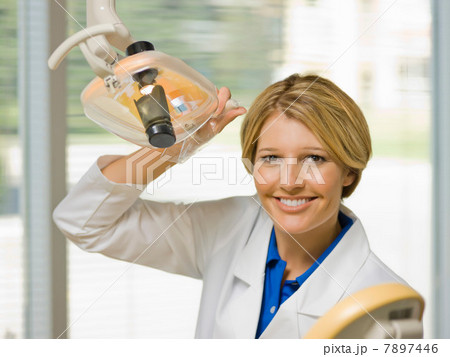 Dentist using dental camera in examining room, portrait Dentist using dental camera in examining room, portrait 7897446