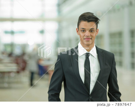 Young businessman in black suit, smiling Young businessman in black suit, smiling 7897647