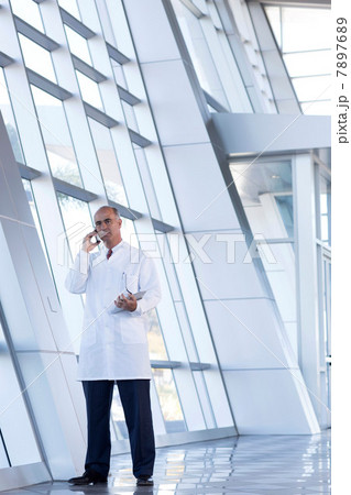 Mature male doctor on cell phone Mature male doctor on cell phone 7897689