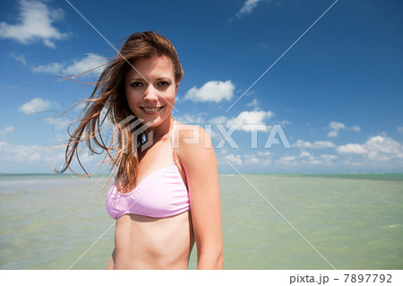 Young woman in sea looking at camera, portrait 7897792