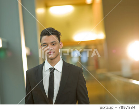 Young businessman in black suit, portrait 7897834