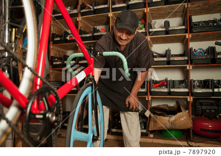 Mechanic working in bicycle shop Mechanic working in bicycle shop 7897920