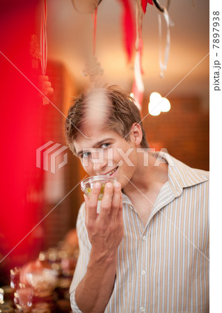 Man smelling preserves in grocery Man smelling preserves in grocery 7897938