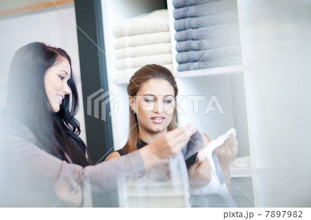 Women shopping for towels in store Women shopping for towels in store 7897982