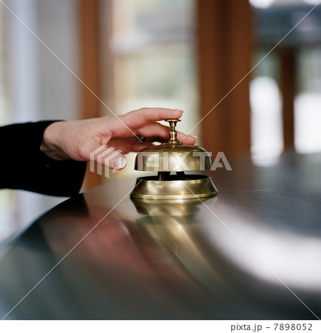 Businesswoman using service bell, close up 7898052
