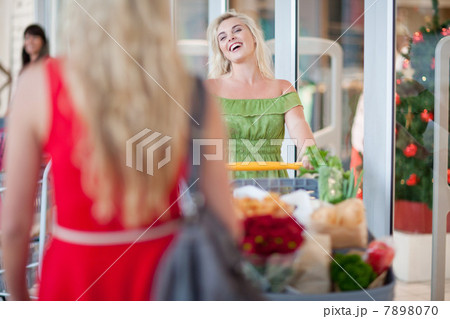 Woman pushing shopping cart Woman pushing shopping cart 7898070