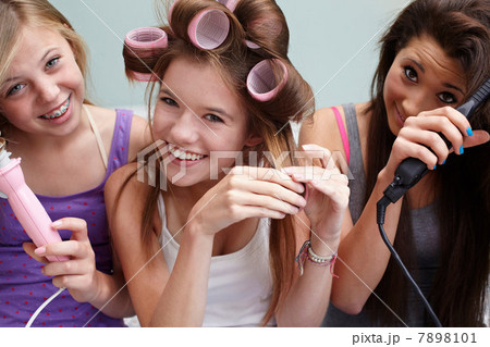 Teenage girls styling their hair 7898101