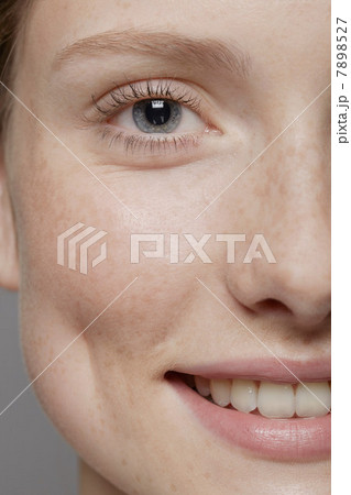 Close up of part of young woman's face, smiling 7898527