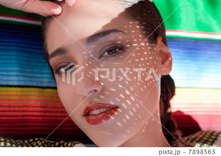 Woman lying on ethnic style blanket, close up Woman lying on ethnic style blanket, close up 7898563