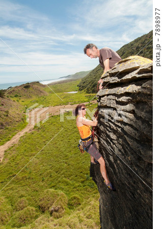 Rock climbers scaling rock, Ruapuke, Raglan, New Zealand Rock climbers scaling rock, Ruapuke, Raglan, New Zealand 7898977
