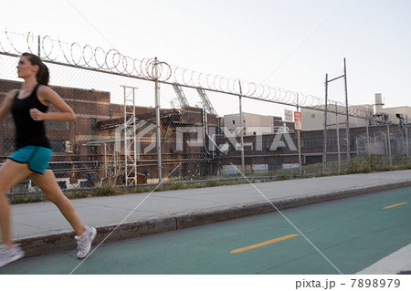 Woman running on road 7898979