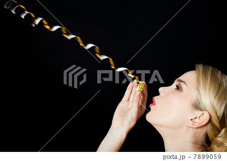 Young blonde woman with party streamer Young blonde woman with party streamer 7899059