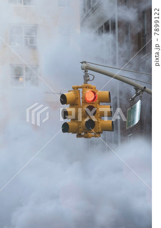 Traffic light on steamy city street 7899122