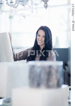 Woman shopping for lamps in store 7899137
