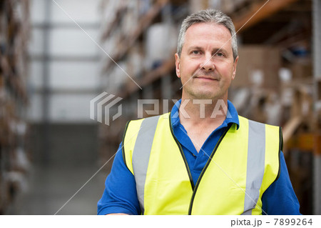 Man wearing high visibility clothing in warehouse, portrait 7899264
