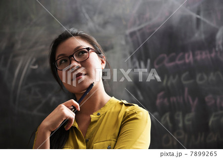 Portrait of woman in front of blackboard 7899265