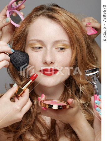 Young woman with make-up artists Young woman with make-up artists 7899670