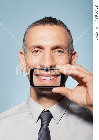 Man covering mouth with smartphone 7899723