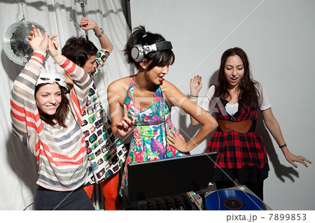 Disc jockey wearing headphones at party 7899853