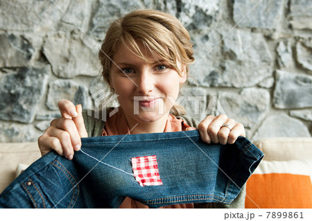 Woman repairing jeans Woman repairing jeans 7899861