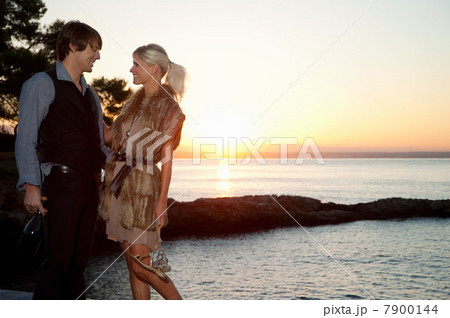 Couple by the sea at sunset Couple by the sea at sunset 7900144