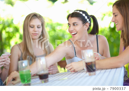 Women playing cards at table 7900337