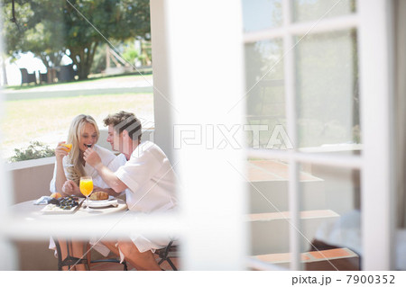 Young couple having breakfast on patio 7900352