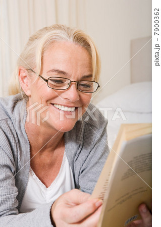 Mature woman reading a book Mature woman reading a book 7900362