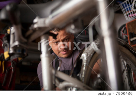 Mechanic working in bicycle shop Mechanic working in bicycle shop 7900436