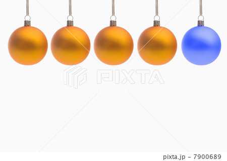 One blue christmas bauble and four yellow christmas baubles One blue christmas bauble and four yellow christmas baubles 7900689