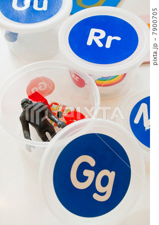 Plastic container with toy gorilla and letter g on lid 7900705
