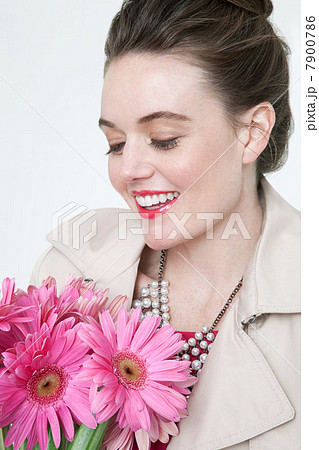Young woman with gerbera flowers 7900786