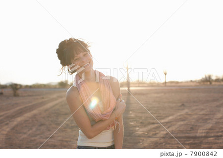 Young woman standing in desert, portrait Young woman standing in desert, portrait 7900842