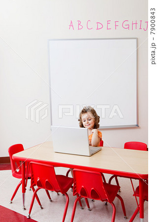 Girl using laptop in classroom Girl using laptop in classroom 7900843