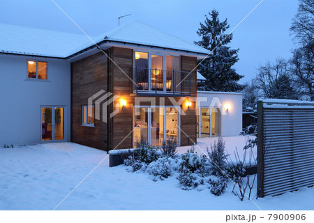 Illuminated family home in snow Illuminated family home in snow 7900906