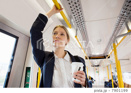 Businesswoman travelling on London Overground train 7901199
