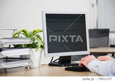 Office worker using computer to update resume 7901247