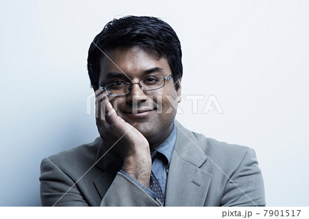 Studio portrait of businessman holding chin 7901517